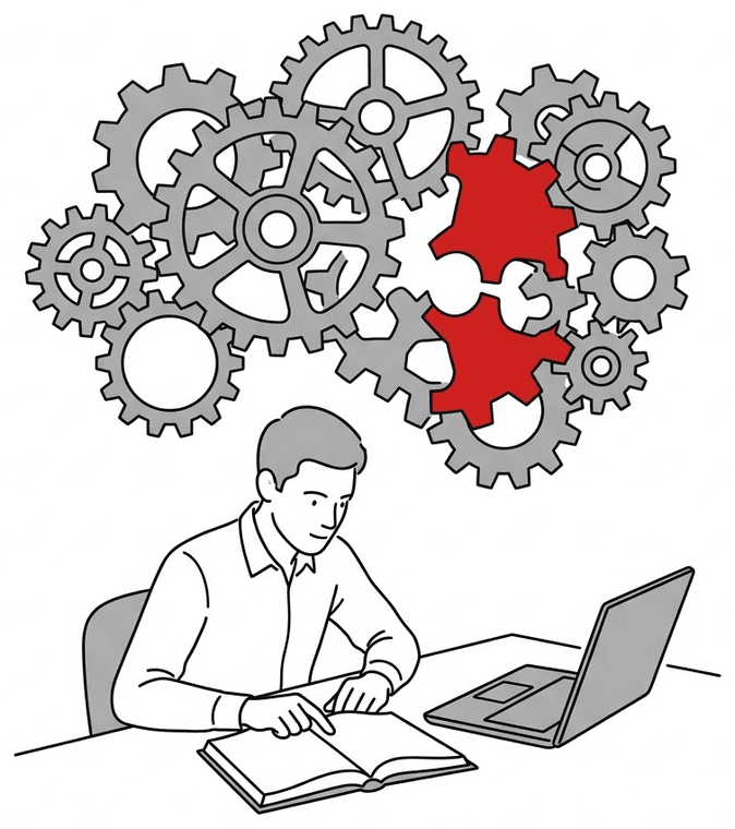 A person reading at a desk beneath a large assembly of grey interlocking gears, with the one piece currently being fitted picked out in red.